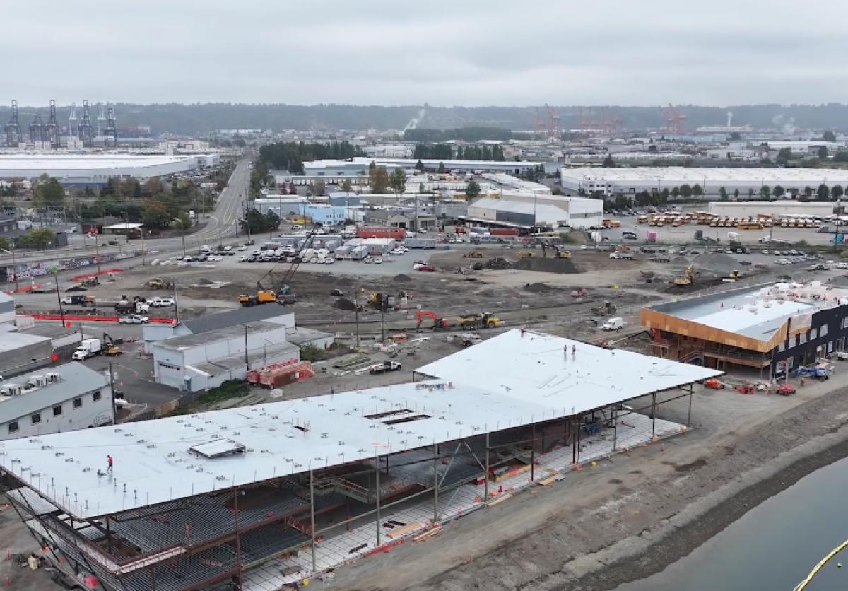 Aerial shot of a building under construction near a waterway.